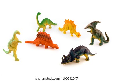 Group Of Toy Plastic Dinosaurs Over White