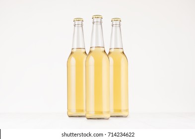 Group transparent longneck beer bottle 500ml with lager, mock up. Template for advertising, design, branding identity on white wood table.
