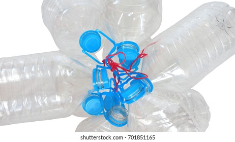 Group of transparent plastic empty bottles with blue cap tied with a red rope on white background