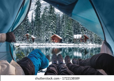 Group of traveler opening tent with wooden lodge in snow forest on Lake O'hara at Yoho national park, Canada - Powered by Shutterstock