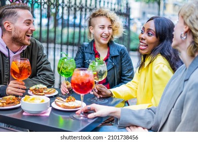 Group Of Trendy Friends Having Fun And Conversation About Life, University And Love While Drinking Cocktails. New Normal Life Post Covid