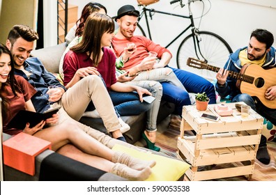 Group Of Trendy Friends Having Fun In Home Living Room - Happy Young People Enjoying Time Together Playing Music And Watching Videos With Tablet - Main Focus On Center Girl Face