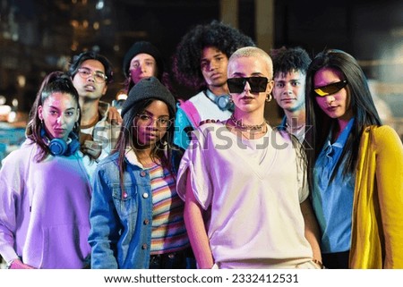 Group of trendy friends in modern funky style looking to camera in the city at night - Young Music Video Dance 商業照片 © 