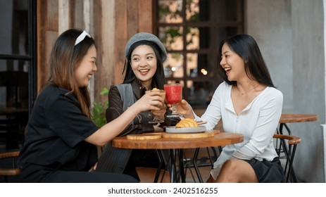 A group of trendy, happy Asian girls are drinking and enjoying talking in a cafe in the city on the weekend together. City life, friendship, lifestyle - Powered by Shutterstock