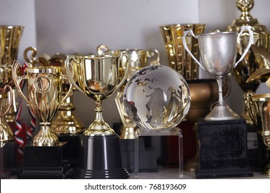 Group Of Trophy Displayed On The Shelf