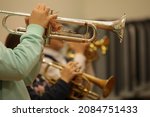 Group of trumpeters boys and girls in a school jazz band playing trumpet together background image of children