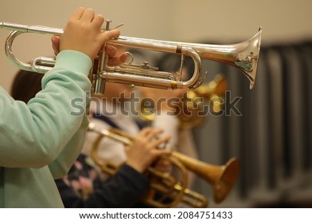 Group of trumpeters boys and girls in a school jazz band playing trumpet together background image of children's creativity