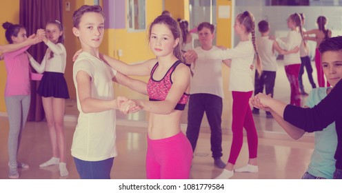Group of tweens training movements of slow foxtrot in dance studio with female coach - Shutterstock ID 1081779584