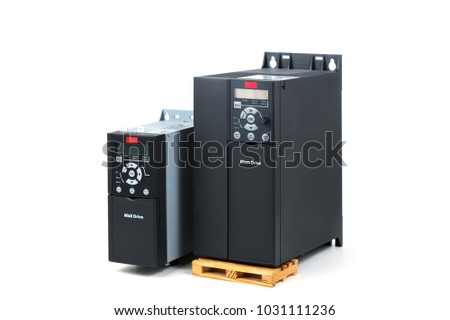 A group of two different sizes and capacities new universal inverter for controlling the electric current and power for industrial on a isolated white background. A frequency converter - rectifier -