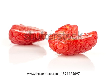 Group of two halves of fresh red raspberry isolated on white background