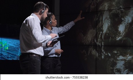 Group Of Two Scientists Observing And Tracking Hurricane On Map And Analyzing Weather. Elements Of This Image Furnished By NASA.