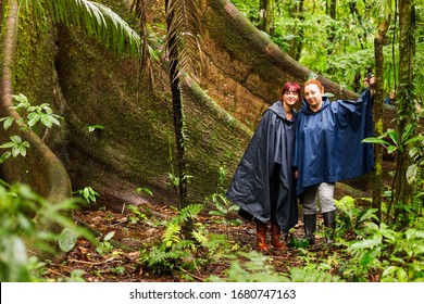 Group Of Two Tourist Friends Against Ceiba Amazonica Tree In Ecuadorian Amazonia Tour Wildlife Drive Amazon Tourist Water Tree Textile River Ecuador Group Jungle Rain Forest Travel Kapok People Commun