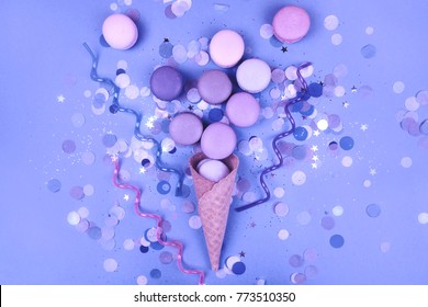Group of Ultra Violet macarons in ice cream corn on trendy blue festive background.