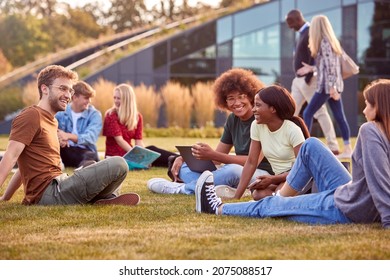 Group Of University Or College Students Sit On Grass Outdoors On Campus Talking And Working - Shutterstock ID 2075088517