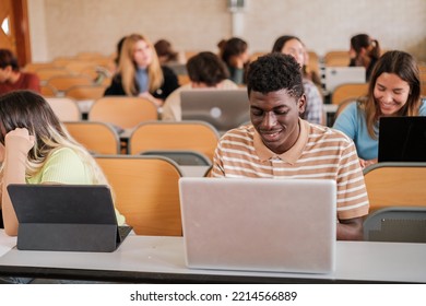 Group of university students attending class with their computers taking notes - Shutterstock ID 2214566889