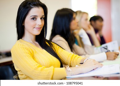 Group Of University Students Sitting In Classroom