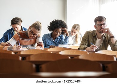 Group Of University Students Taking A Test In A Classroom.Educational Concept.	
