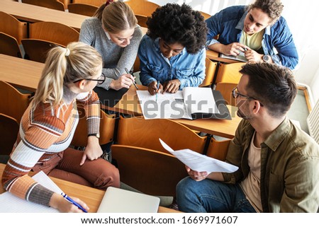 Group of university students taking a test in a classroom.Educational concept.	
