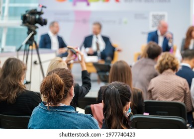 Group of unrecognizable speakers sitting on stage and discussing contemporary business technologies in auditorium with audience - Shutterstock ID 1977740423