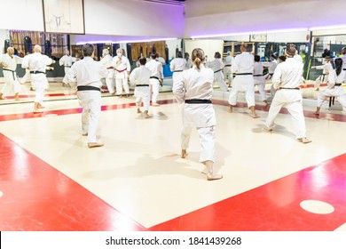 Group Of Unrecognizable Young Adults Training In A Karate Class