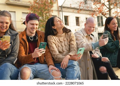 Group of urban friends using smartphone at urban place outdoor, Young people sharing content with mobile smart phone , Happy student having fun at university college yard-Tech lifestyle Concept 