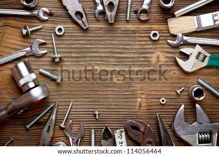 Group of used tools on wood background
