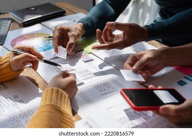 Group of ux developer and ui designer brainstorming about app interface design at modern office. Creative digital development agency