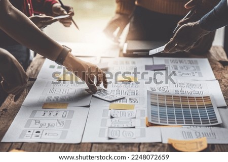Group of ux developer and ui designer brainstorming about app interface design at modern office. Creative digital development agency