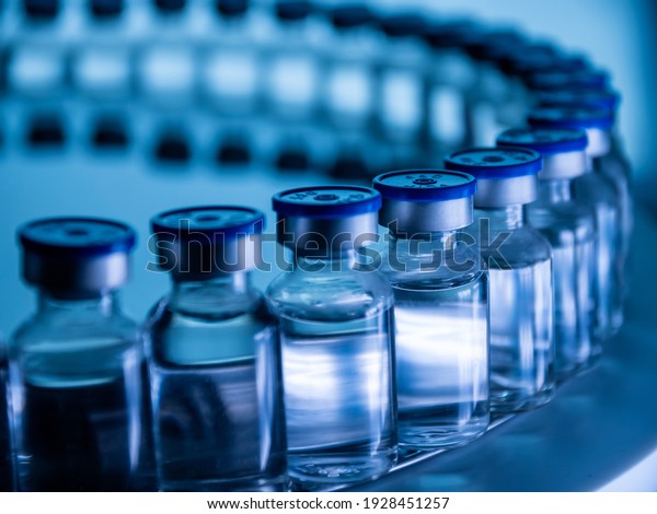 Group of Vaccine bottles. Medicine\
in ampoules. Glass vials for liquid samples in\
laboratory.