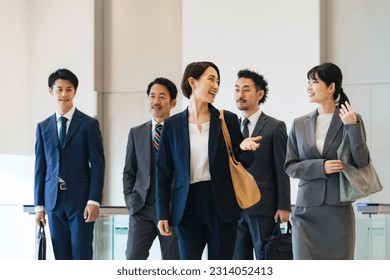 Group of various generation Asian businesspeople walking in lobby. Company employees who challenge for success. - Powered by Shutterstock