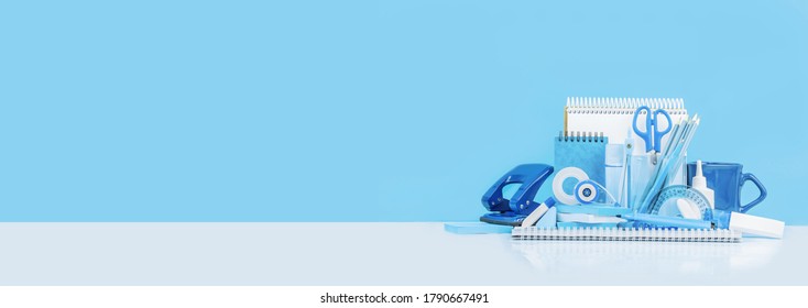 Group Of Various Office Supplies And School White And Blue Stationery On Desk. Blue Background Monochrome. Banner For Back To School Or Education And Craft Concept. Selective Focus. Copy Space