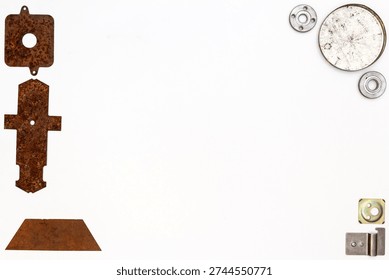 A group of various old and new bits and pieces arranged on white. Old rusty nuts, bolts, nails and other parts flay lay on white background.