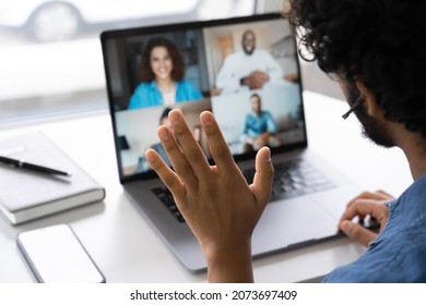 Group Video Conference Or Business Videocall Chat On Laptop Computer Screen. Male Waving Hand Greeting Colleague Or Coworker Team At Digital Meeting Room. Online Training Or Remote Interview