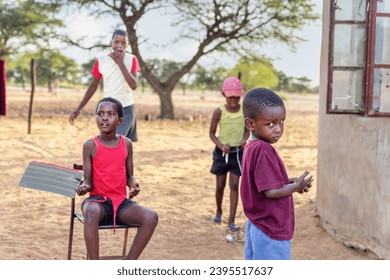 group of village african kids playing in the yard - Shutterstock ID 2395517637