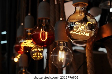 Group of vintage electric light bulbs,  Retro edison bulb led filament Lamp LOVE  in dark background.