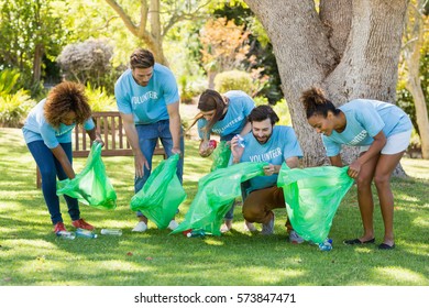 Group Of Volunteer Collecting Rubbish In Park