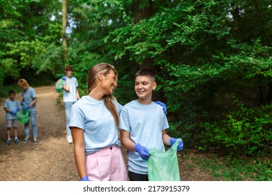 Group Of Volunteers Cleaning Up Forest From Waste, Community Service Concept