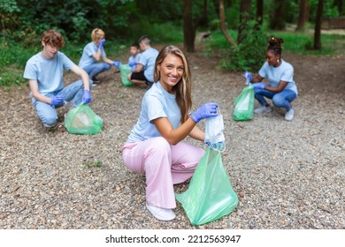 Group Of Volunteers Cleaning Up Forest From Waste, Community Service Concept