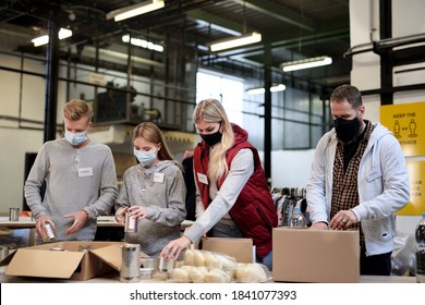 Group Of Volunteers In Community Charity Donation Center, Food Bank And Coronavirus Concept.