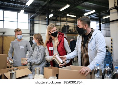 Group Of Volunteers In Community Charity Donation Center, Food Bank And Coronavirus Concept.