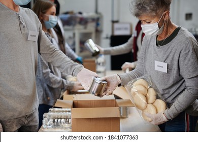 Group Of Volunteers In Community Donation Center, Food Bank And Coronavirus Concept.