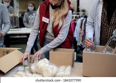 Group Of Volunteers In Community Donation Center, Food Bank And Coronavirus Concept.