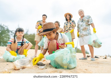 Group of Volunteers multi-Generation family picking up plastic trash and garbage together at the beach on summer holiday vacation. Environmental conservation earth day and waste pollution concept. - Powered by Shutterstock