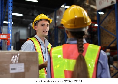 Group Of Warehouse Workers With Hardhats And Reflective Jackets Using Tablet, Walkie Talkie Radio And Cardboard While Controlling Stock And Inventory In Retail Warehouse Logistics, Distribution Center