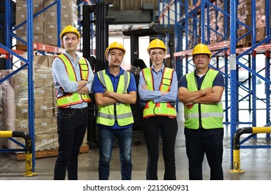 Group Of Warehouse Workers With Hardhats And Reflective Jackets Standing And Crossed Arms With Confident Celebrate Successful Together Or Completed Deal At Retail Warehouse Logistics Center