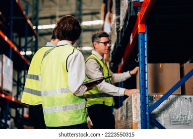 Group of warehouse workers with safety vest talking and discussing plan together, Workers checking and controlling goods working in store factory, Warehouse worker with teamwork concept - Powered by Shutterstock