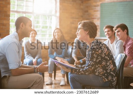 Group watching man and woman talking in group therapy session