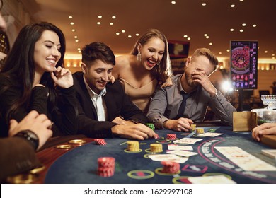 A Group Of Wealthy Young People Gamble At A Casino.