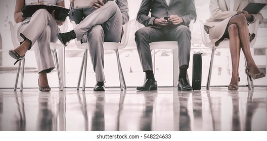 Group of well dressed business people waiting in waiting room