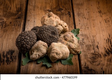 group of white and black truffle over wood background
